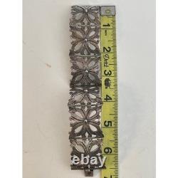 Bracelet vintage en argent sterling mexicain avec charnière, design floral découpé, en excellent état d'usage.